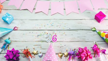 Happy birthday number 36. Copyspace. Beautiful card in pastel pink colors for a woman or a girl. Decorations festive place for your text.