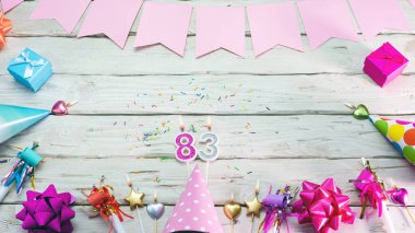 Happy birthday number 83. Copyspace. Beautiful card in pastel pink colors for a woman or a girl. Decorations festive place for your text