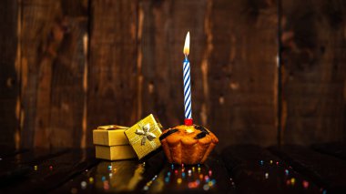 Scenery Festive background with gift boxes happy birthday copy space. Anniversary background with cypher and muffin. Beautiful brown from vintage boards background before a birthday with a number 5