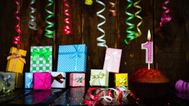 Party birthday background with number 1. Beautiful background anniversary copy space with burning candles. Gift boxes with decorations.