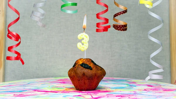 Happy birthday background with muffin with beautiful decorations with number candles  3. Colorful festive card happy birthday with a number. Anniversary copy space