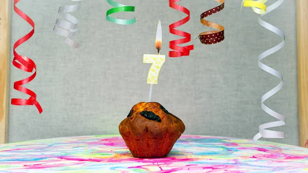 Happy birthday background with muffin with beautiful decorations with number candles  7. Colorful festive card happy birthday with a number. Anniversary copy space