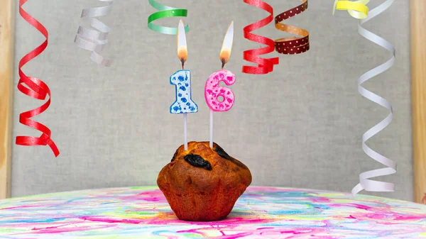 Happy birthday background with muffin with beautiful decorations with number candles  16. Colorful festive card happy birthday with a number. Anniversary copy space