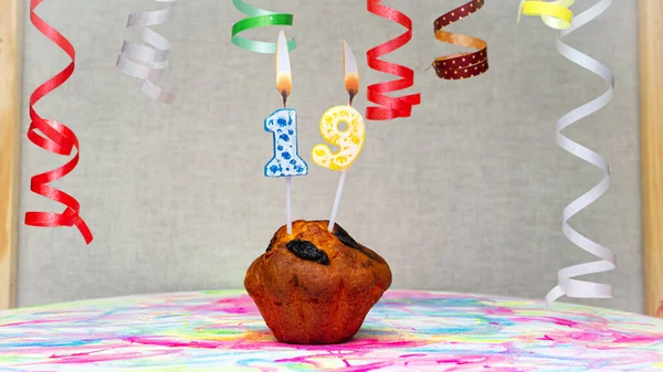 Happy birthday background with muffin with beautiful decorations with number candles  19. Colorful festive card happy birthday with a number. Anniversary copy space