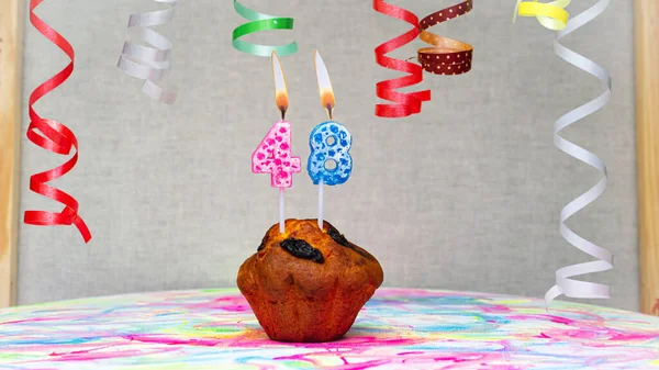 Happy birthday background with muffin with beautiful decorations with number candles  48. Colorful festive card happy birthday with a number. Anniversary copy space