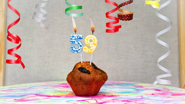 Happy birthday background with muffin with beautiful decorations with number candles  59. Colorful festive card happy birthday with a number. Anniversary copy space