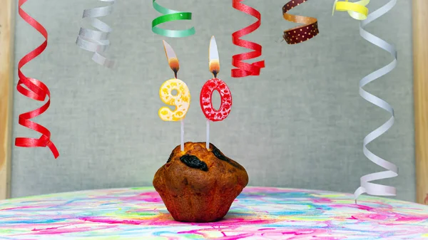Happy birthday background with muffin with beautiful decorations with number candles  90. Colorful festive card happy birthday with a number. Anniversary copy space