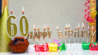 Happy birthday background with golden candles and decorations with candles burning number  60. Colorful festive card happy birthday with a number. Anniversary copy space