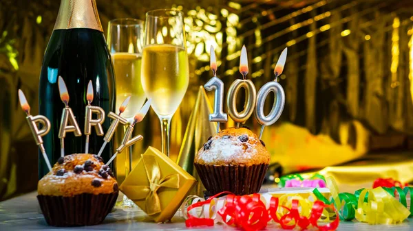 Happy birthday background with champagne glasses with number cake  100. Beautiful birthday card with decorations copy space.