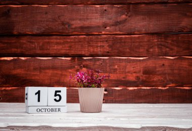 October calendar with number  15. Planner copy space on a wooden brown background. March number icon. Place for text background calendar