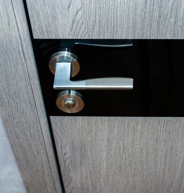 Modern office door handle. Wooden door with a lock minimalism.