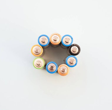 Top view of multi-colored batteries. Alkaline finger batteries, copyspace.