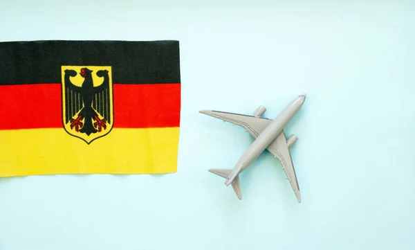 Top view Passenger plane flying over the German flag with an eagle. The concept of tourism and travel around the world. copy space