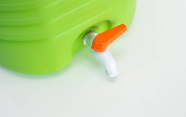 Washstand tourist plastic green on a white background. Wash-hand basin with white plastic faucet with screw.