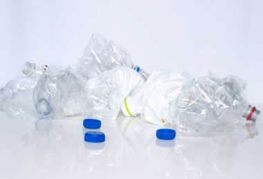 Empty twisted plastic bottles on a white background. Used plastic bottles trash.