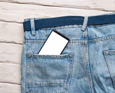 Smartphone with white screen in jeans pocket. Smartphone with white display copy space. Phone message concept.