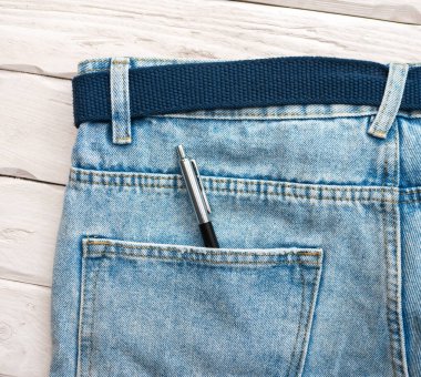 Top view of a push-button pen in a jeans pocket. Message concept. Notes for text. Letter copy space.