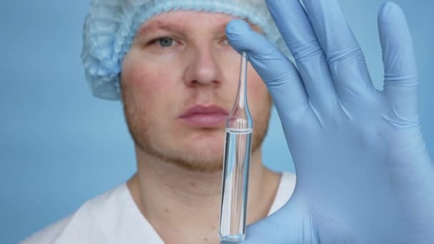 Slow Motion Doctor Dressing Gown Sterile Mittens Demonstrates Medicine Ampoule — Stock Video
