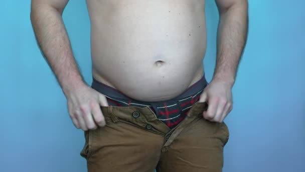 Tlustý Mladý Muž Snaží Obléct Džínové Kalhoty Muž Velkým Břichem — Stock video