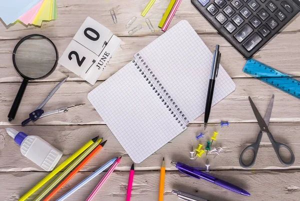 stock image June calendar with number  20. Copy of space note. Top view of blank notepad. Space for text in a checkered sheet, stationery background with accessories.