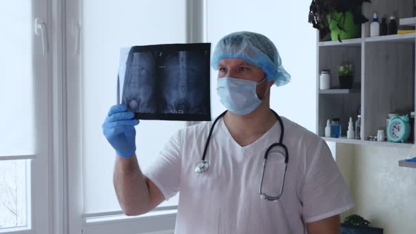 输尿管内8毫米的微积分在医生手上的X光片上 泌尿科医生分析人体肾的X光检查 X光下的石病脊髓损伤 — 图库视频影像