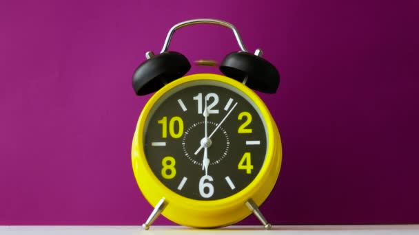 美しい紫色の背景にレトロアラーム時計リング 目覚まし時計はベッドで寝ている人を起こします レトロアラーム時計リング大声で — ストック動画
