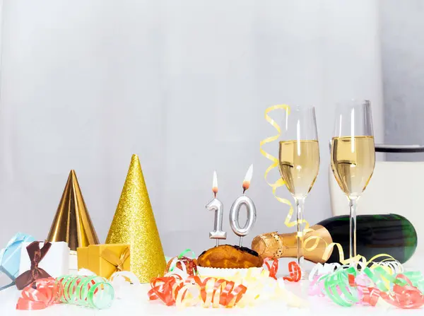Date of Birth  10. Festive background with a bottle of champagne. Festive Champagne in glasses with gift boxes, anniversary card, happy birthday decorations in white colors