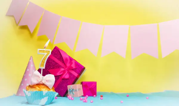 Date of birth with cake and number  7. Colorful card happy birthday for a girl. Copy space. Anniversary card pink. Congratulations on the decorations are beautiful.
