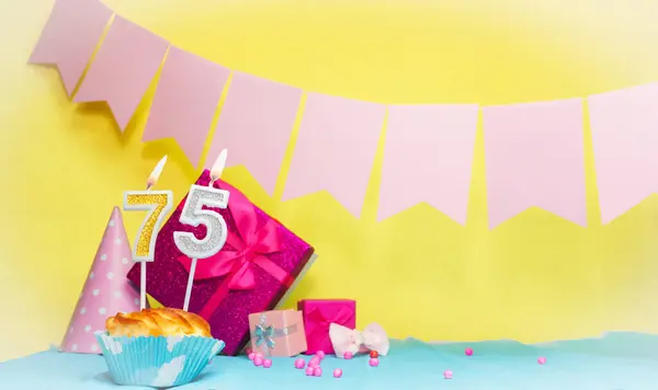 Date of birth with cake and number  75. Colorful card happy birthday for a girl. Copy space. Anniversary card pink. Congratulations on the decorations are beautiful.