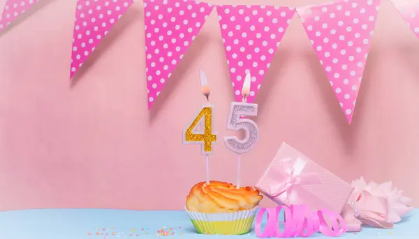 Date of Birth  45. Greeting card in pink shades. Anniversary candle numbers. Happy birthday girl, polka dot garland decoration. Copy space.
