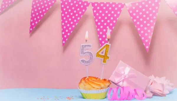 Date of Birth  54. Greeting card in pink shades. Anniversary candle numbers. Happy birthday girl, polka dot garland decoration. Copy space.