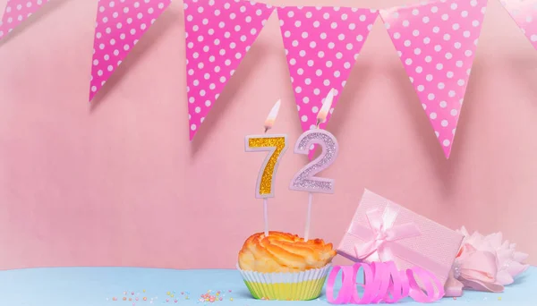 Date of Birth  72. Greeting card in pink shades. Anniversary candle numbers. Happy birthday girl, polka dot garland decoration. Copy space.