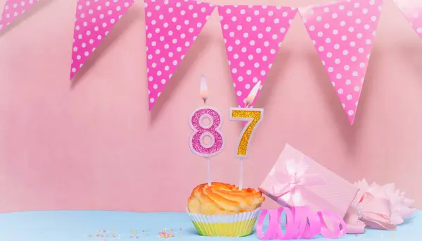 Date of Birth  87. Greeting card in pink shades. Anniversary candle numbers. Happy birthday girl, polka dot garland decoration. Copy space.