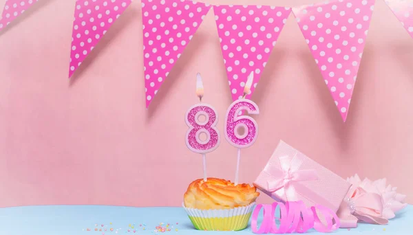 Date of Birth  86. Greeting card in pink shades. Anniversary candle numbers. Happy birthday girl, polka dot garland decoration. Copy space.