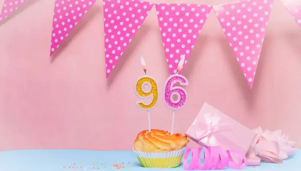 Date of Birth  96. Greeting card in pink shades. Anniversary candle numbers. Happy birthday girl, polka dot garland decoration. Copy space.