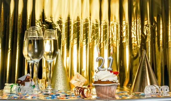 Background date of birth with number 21. Scenery festive glasses of champagne, anniversary in golden color. Copy space. Happy birthday postcard.