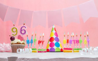 Doğum tarihi 96 'nın geçmişi. Yıldönümü. Bir kız için mumlarla dolu güzel bir arka plan. Kadınların tebrik kartı. Pembeli mutlu yıllar..