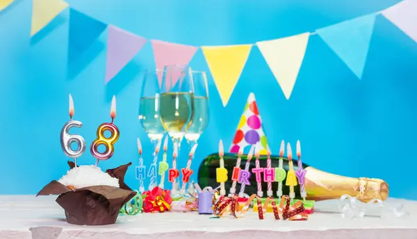 Date of birth with candles and number  68. Anniversary greeting card. Holiday decorations. Happy birthday candles. Multicolored decorations with garland