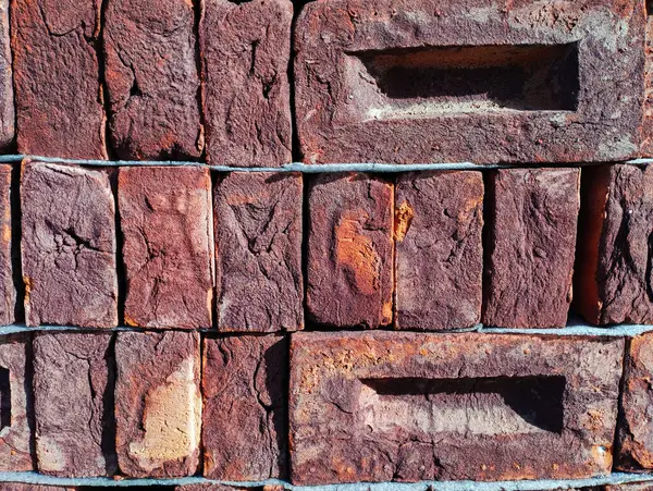 Red brick on a wooden pallet. Construction red clay brick.