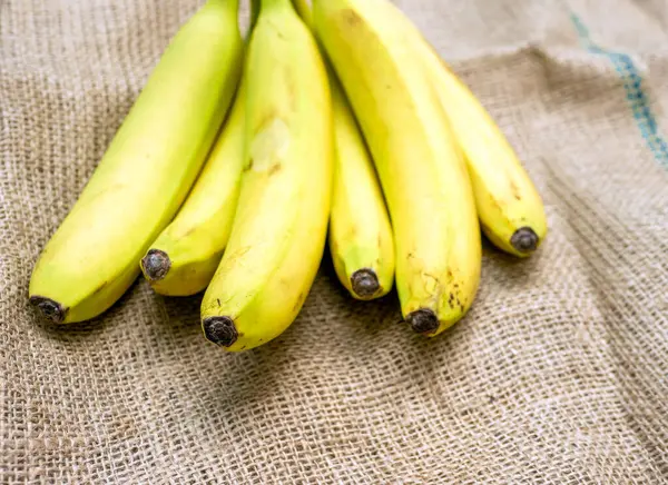 Ripe bananas on an old bag. Beautiful yellow bananas close-up. Vtamin fruits