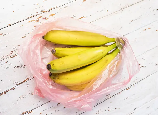 Bananas in a transparent grocery bag, ripe bananas in a plastic bag