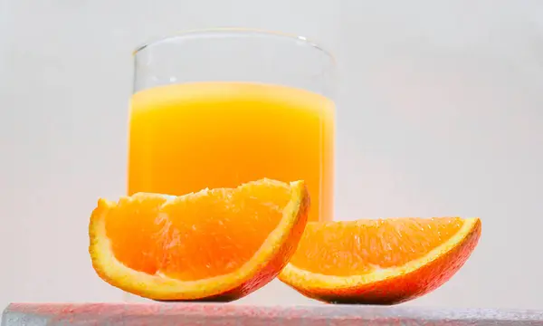 Juice with a straw in a glass. Summer orange drink with orange slices. Soda in a transparent glass. Apperol alcoholic drink. Natural juice with ice. Multivitamin fresh squeezed.