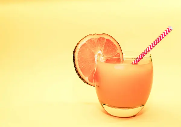 Summer orange drink with orange slice. Soda in a transparent glass. Alcoholic drink Apperol. Natural juice with ice. Fresh vitamin cocktail