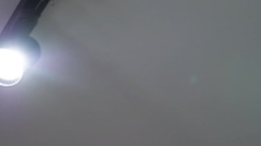 Tavanda benekli lamba izi var. Ağır çekimde kay. Elektrik avizesi, modern siyah