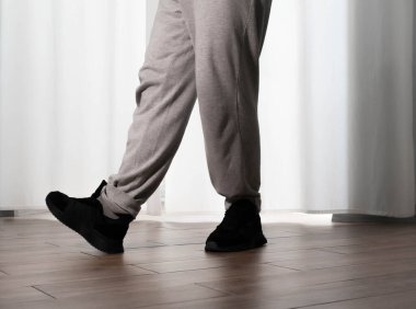 Hareketli dans, hip-hop tarzı giyinmiş bir adamın pozu. Antrenmandaki spor dansçısı poz veriyor. Evde dans eğitimi..