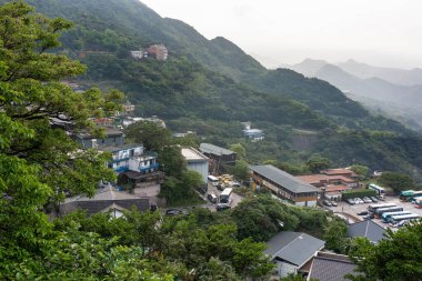 Taipei , Taiwan - March 26, 2024 :  Top View of Jiufen old city in New Taipei City's Ruifang District at evening, Jiufen, Taiwan.Overcast clipart