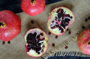Kahverengi peçetedeki kırmızı olgun nar manzarası. Yüksek kalite fotoğraf