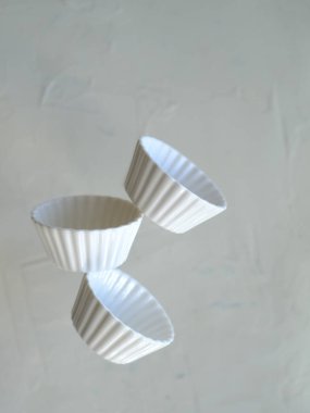 Flying white bowls in levitation on air. High quality photo
