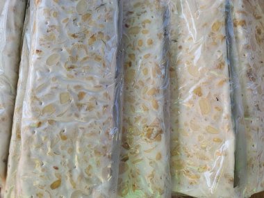 Close up of raw tempe made of fermented soy beans plastic wrapped