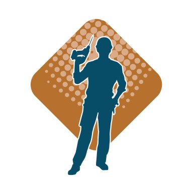 Matkap aletleri taşıyan inşaat işçisi kostümlü bir adamın silueti. İnşaat işçisi erkek silueti elektrikli matkapla hareket halinde poz veriyor. 